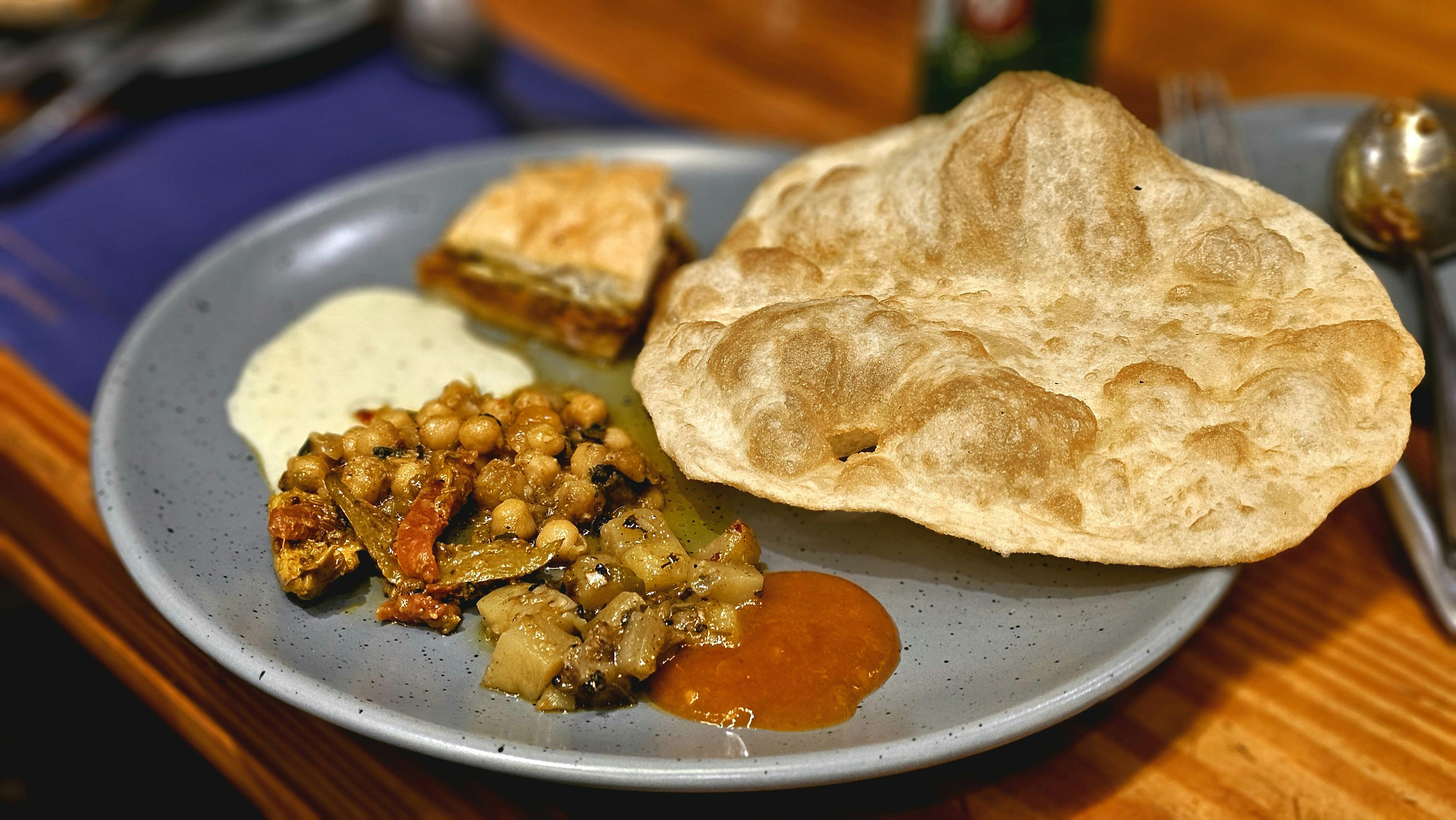 close-up of Indian white chaney with puri and chutneys